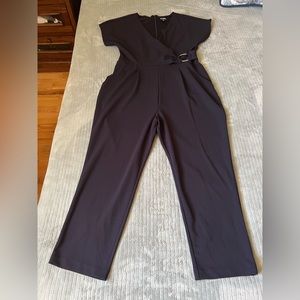 Express wrap V-neck jumpsuit with metal ring detail.